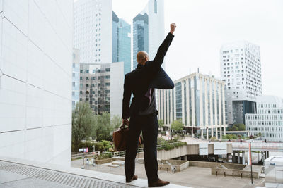 Low angle view of man standing against building