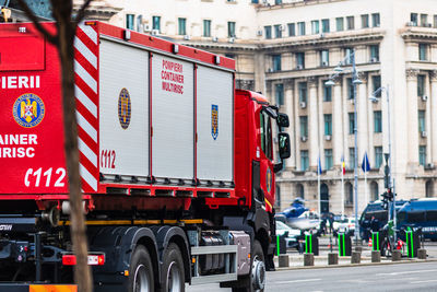 Vehicles on road against buildings in city