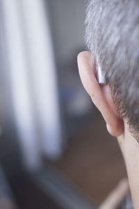 Close-up of man with hearing aid