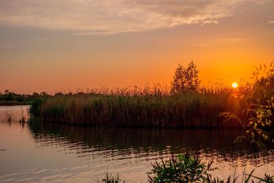 Scenic view of sunset over lake