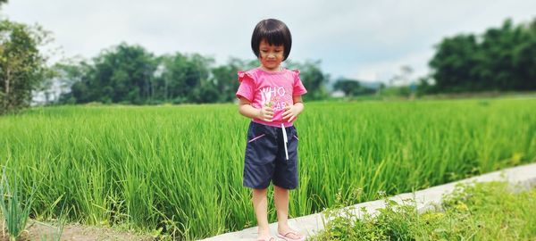 Portrait of boy standing on field