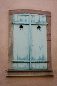Beautiful light blue painted wooden window shutters in a medieval house, colmar, alsace, france