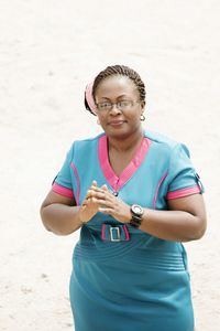 Portrait of woman standing at beach