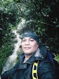 Portrait of smiling young woman in forest