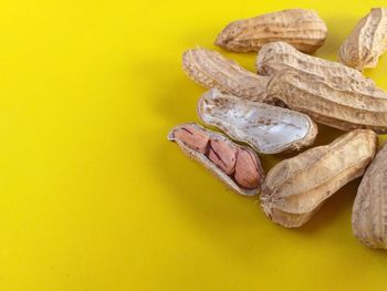 Close-up of shoes on table against yellow background