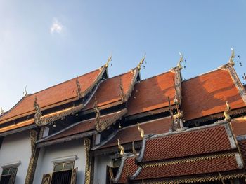 Low angle view of roof and houses against sky