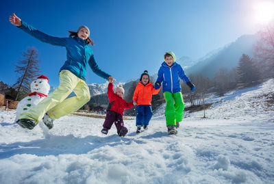 People skiing on snow covered mountain