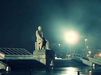 Memorial statue in park at night