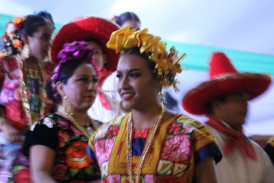 Portrait of young woman dancing in traditional clothing during festival