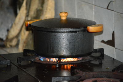 Pan on fire over the stove at home