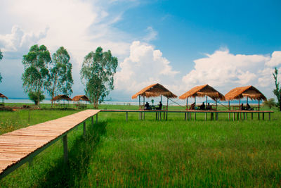 Houses on field against sky