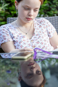 Portrait of young woman using mobile phone