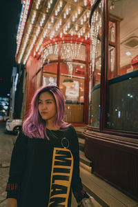 Portrait of young woman standing in train