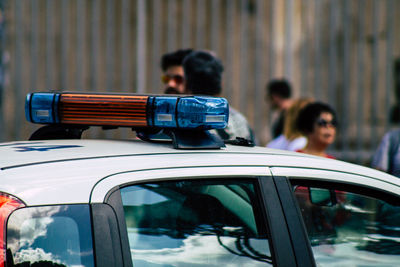 People in city seen through car window