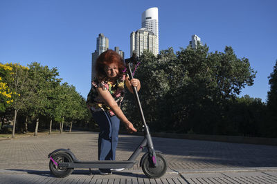 Low angle view of woman sitting on street