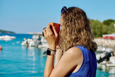 Rear view of woman using mobile phone