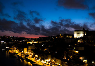 High angle view of illuminated buildings against sky at night