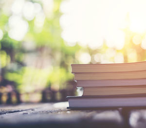 Close-up of stacked books on table outdoors