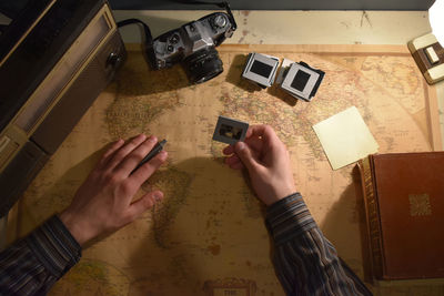 Vintage workspace with books, camera, radio and world map