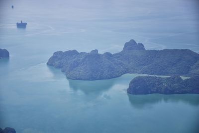 Rock formation in sea against sky