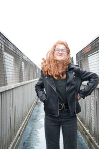 Portrait of girl standing on footbridge