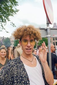 Portrait of young man wearing sunglasses while standing in city