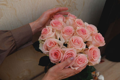 Midsection of bride holding bouquet