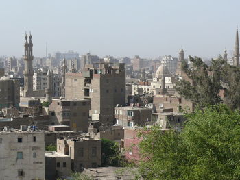 Buildings in city against clear sky