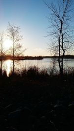 Scenic view of lake against sky at sunset