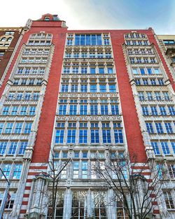 Low angle view of modern building against blue sky