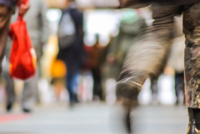 Defocused image of people walking on street