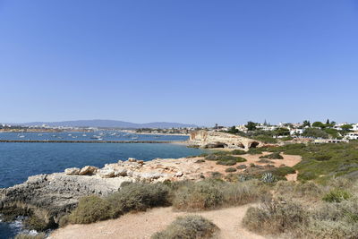 Scenic view of sea against clear blue sky