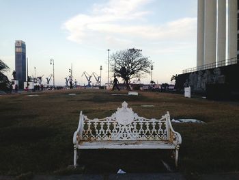 Gazebo by trees in city against sky