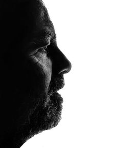 Close-up of thoughtful mature man against white background