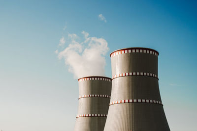 Low angle view of smoke stack against sky