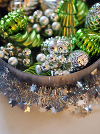 Close-up of christmas decorations in container on table