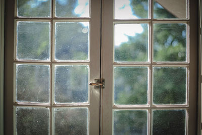 Close-up of window in front of door