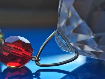 Close-up of crystal jewelry on glass table