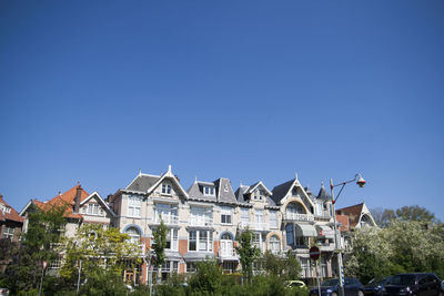 Low angle view of buildings against blue sky