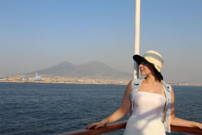 Woman standing against sea