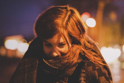 Close-up portrait of young woman at night