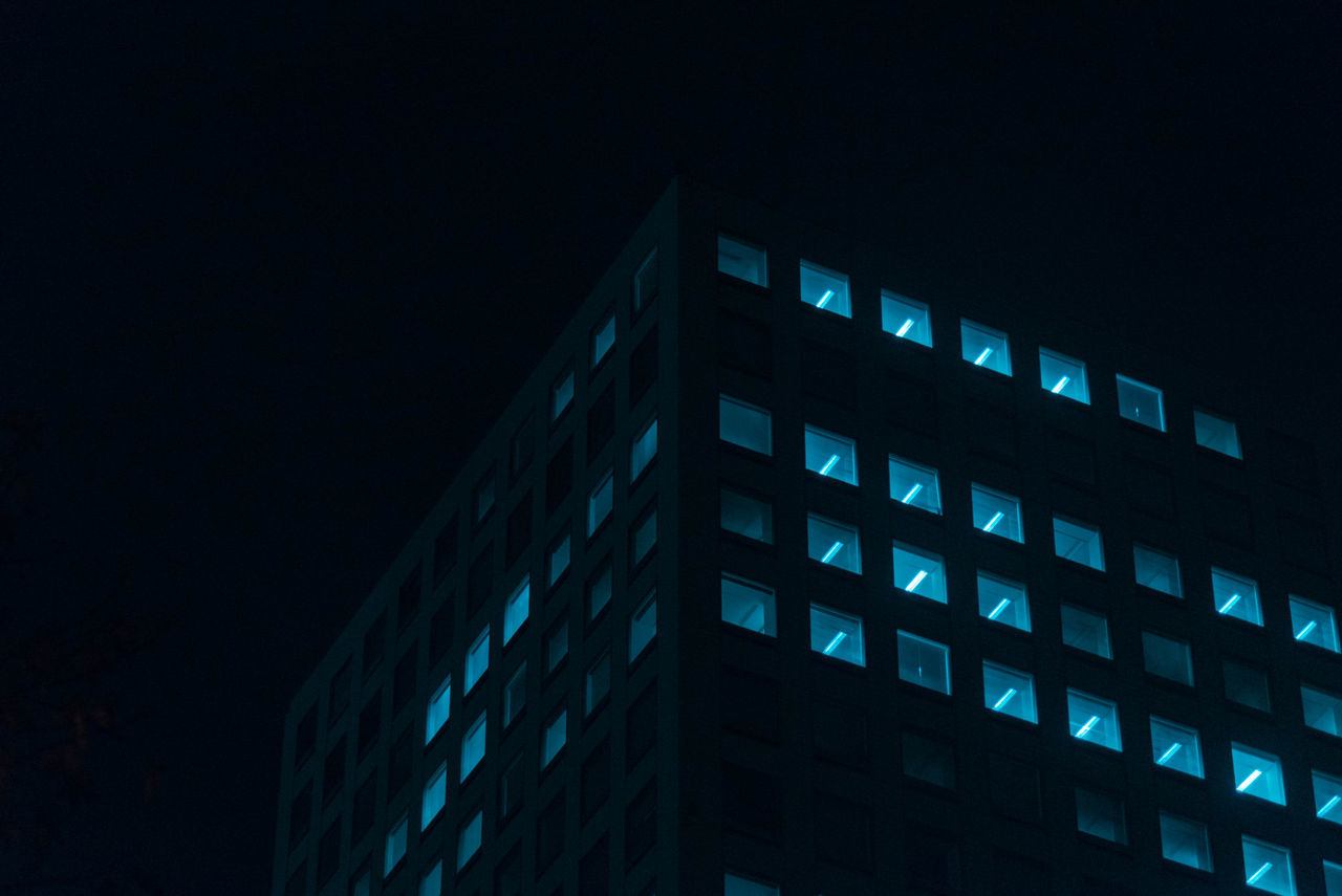 LOW ANGLE VIEW OF MODERN BUILDING AGAINST CLEAR SKY AT NIGHT