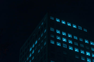 Low angle view of illuminated building against sky at night