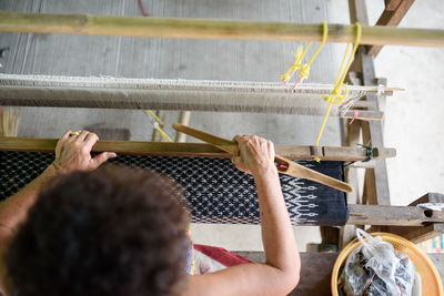 Low section of man working on wood