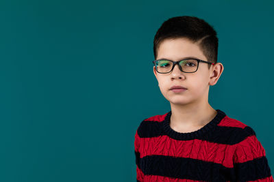 Portrait of young man against blue background