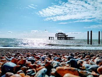 Stones on beach against sky