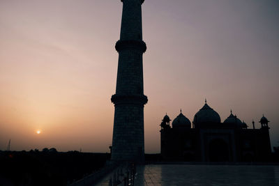 Low angle view of mosque against sky during sunset