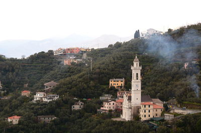 Buildings in town against sky