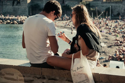 Rear view of couple holding hands