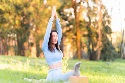 Midsection of woman with arms raised